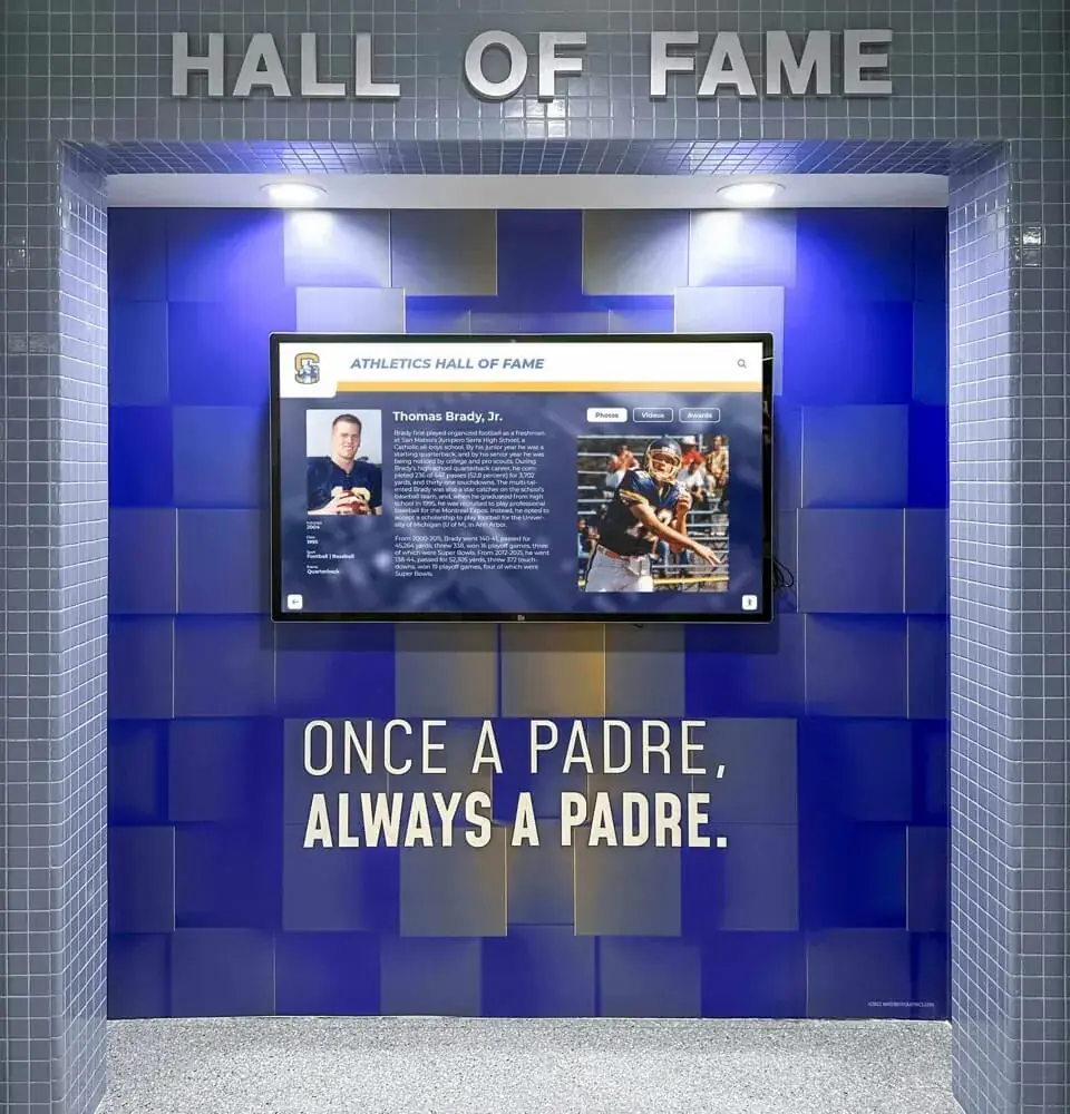 A Hall of Fame touchscreen in a blue tiled alcove above the words Once a Padre, Always a Padre