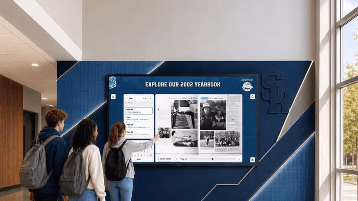 Students stop at a hallway display showing scanned yearbook photos